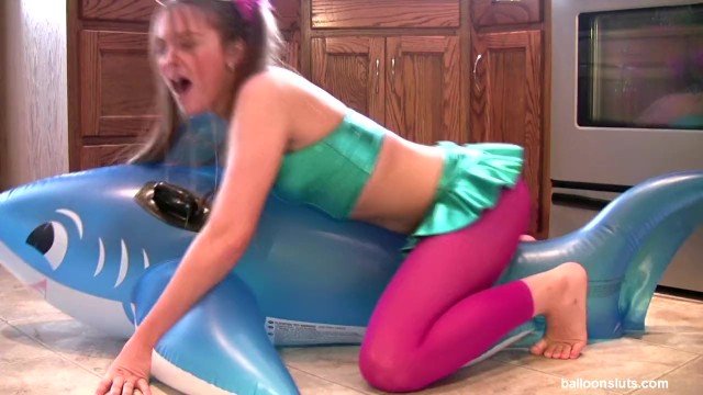 Girl humping a inflatable whale.